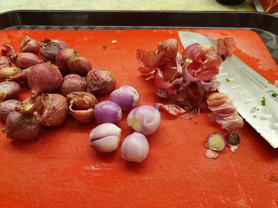 Cutting shallots for Penne with Seafood and Vegetables in Curry Flavour