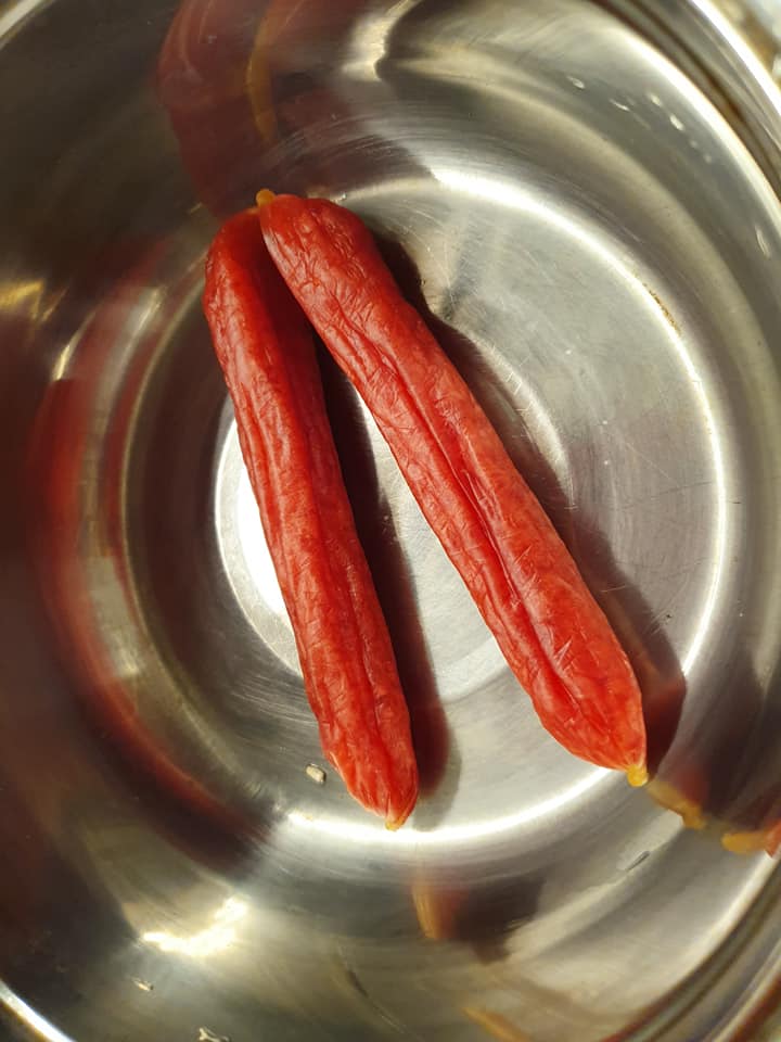Soaking the Chinese Preserved Sausage in hot boiling water