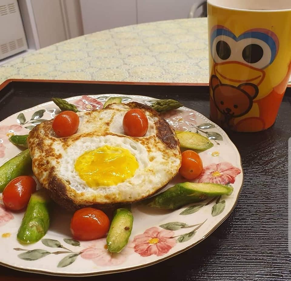 Fried Egg with self made bread on bed of Asparagus & Cherry Tomatoes, one cup Nescafe Gao Siew Dai 