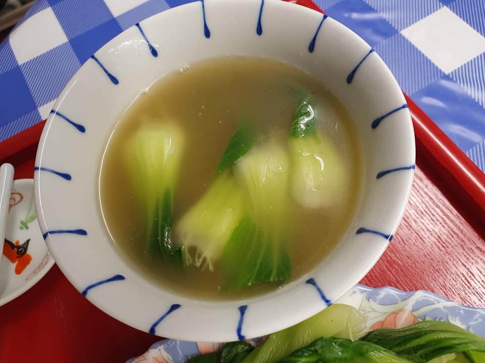 A bowl of Soup with Greens